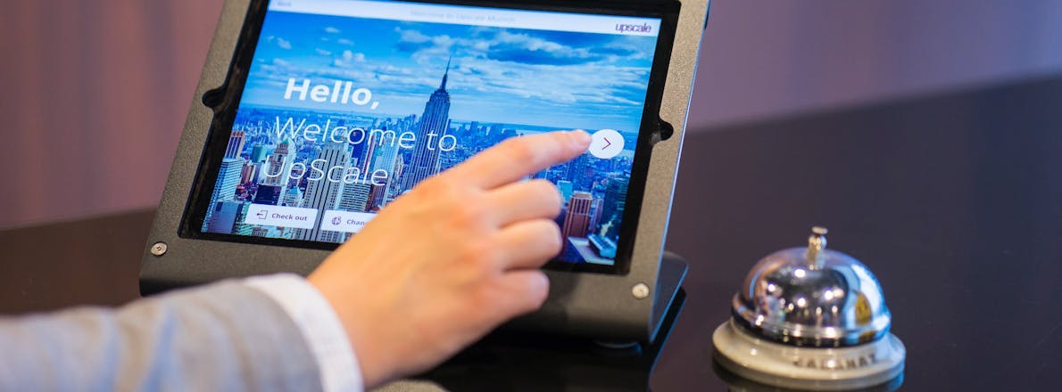 Person checking into a hotel on a tablet